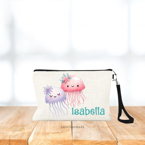 This zippered pouch features two jelly fish, one purple, one pink. And is personalized is with your name in teal glitter color.