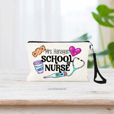 Linen wristlet that says School Nurse with the name on top of it. There is nursing clipart surrounding title. bandage, Heart, Thermometer, Stethoscope and nurse fuel coffee.