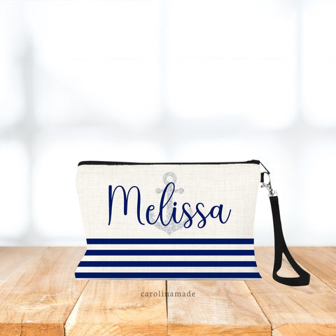 This bag features a nautical theme with navy stripes at the bottom portion and a printed silver glitter anchor with a name personalized over top of it.