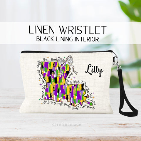 This linen zipper pouch is the perfect accessory for your trip to Mardi Gras! It features a Louisiana state in mardi gras colors yellow, green and purple colors with beads hanging off it. It is personalized with your name on the top corner.